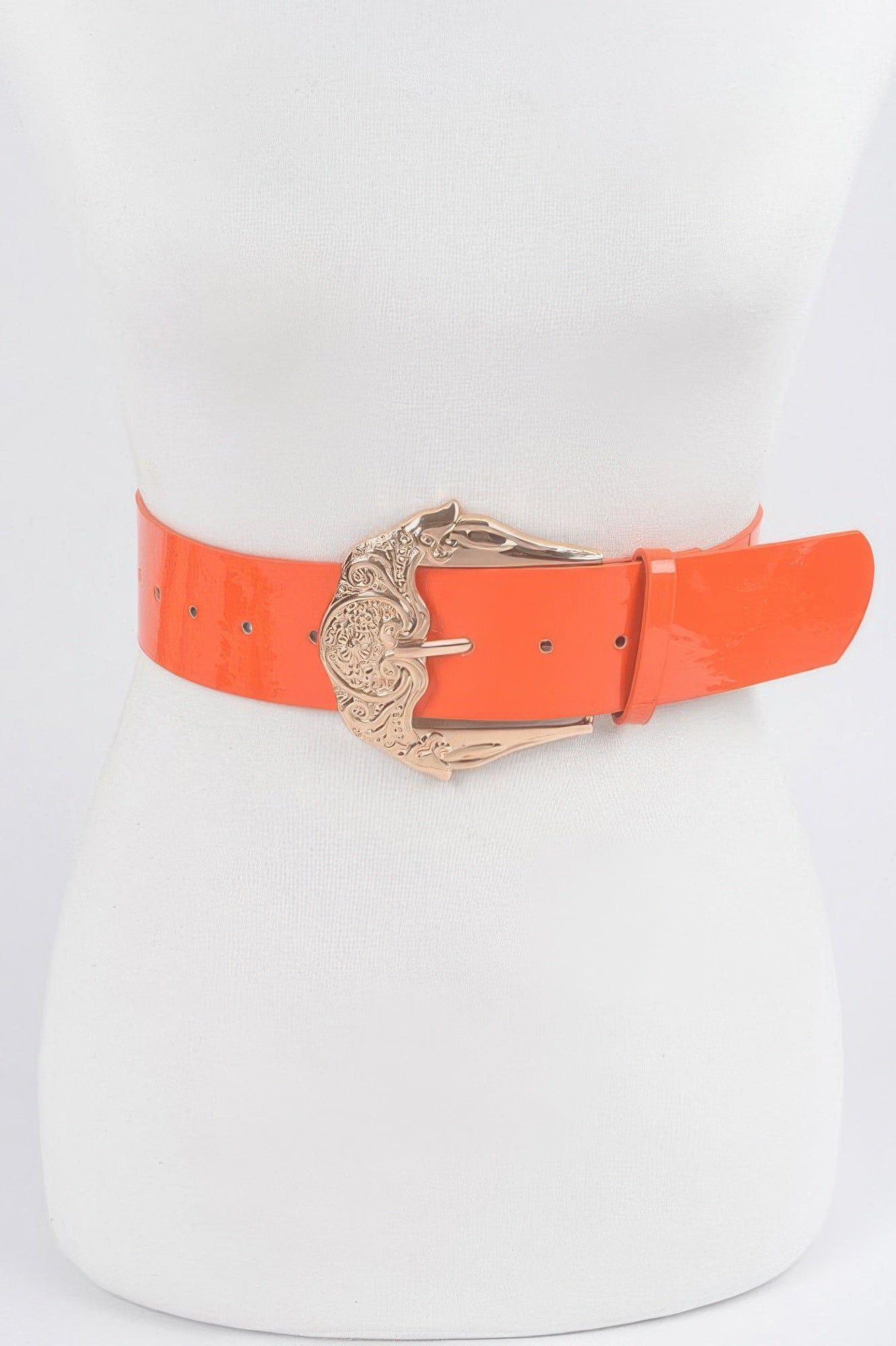 Shiny enamel belt in orange with ornate gold-tone metal buckle and eyelets