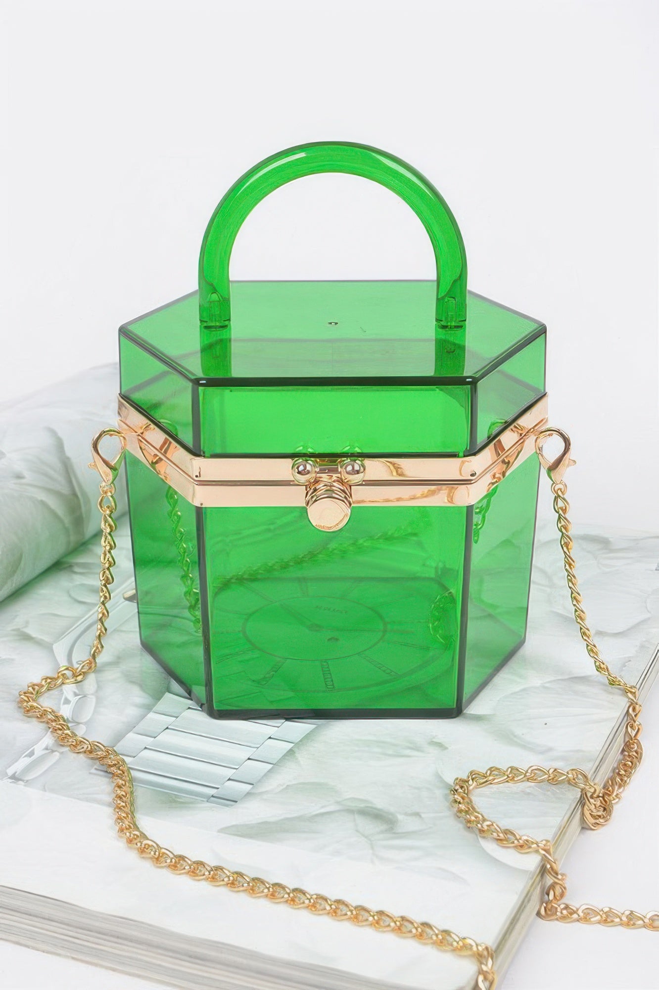 Translucent yellow plastic mini clutch with top handle and gold chain strap