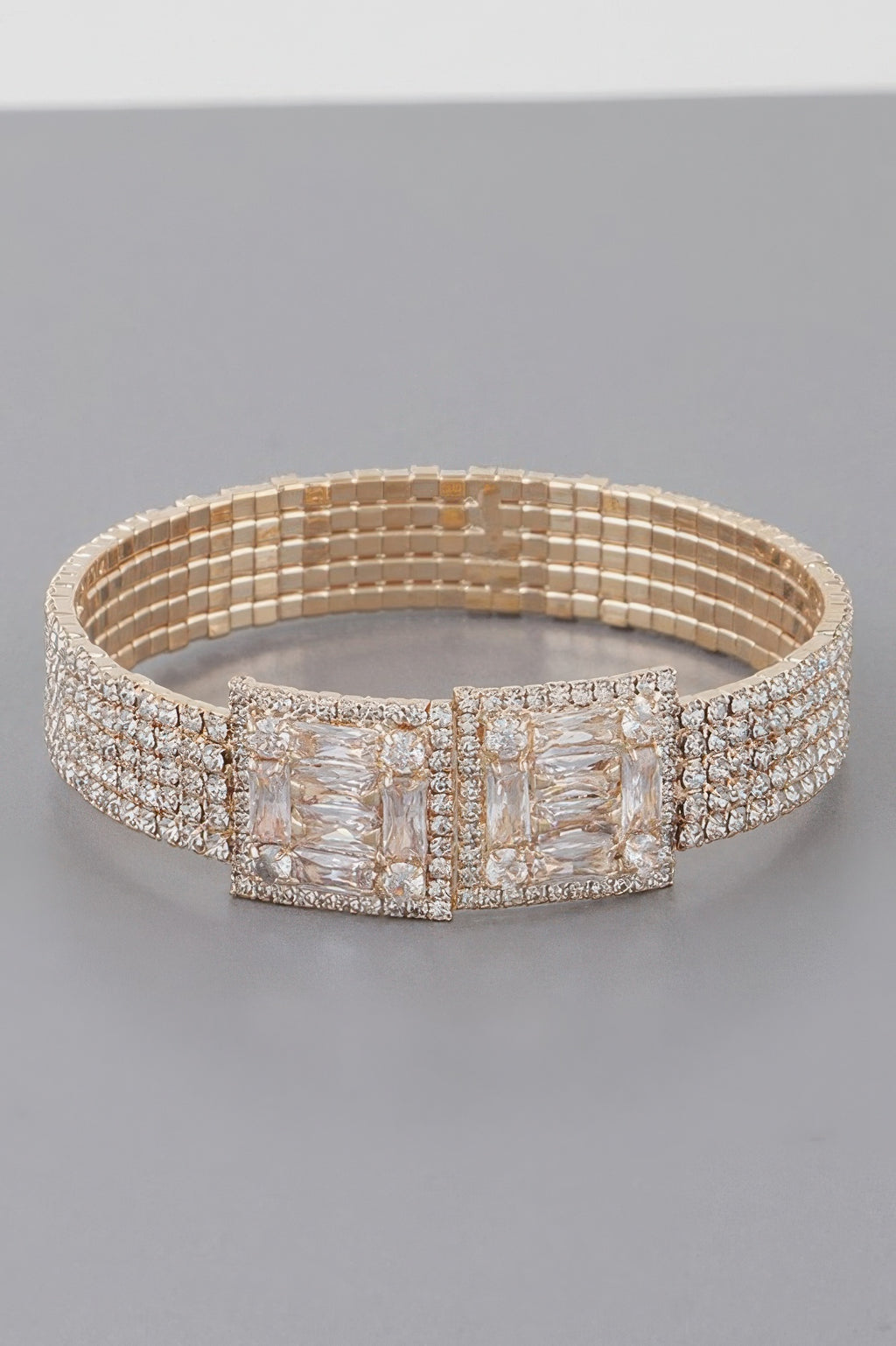 Crystal block bracelet in gold tone with wide clear stone center panel