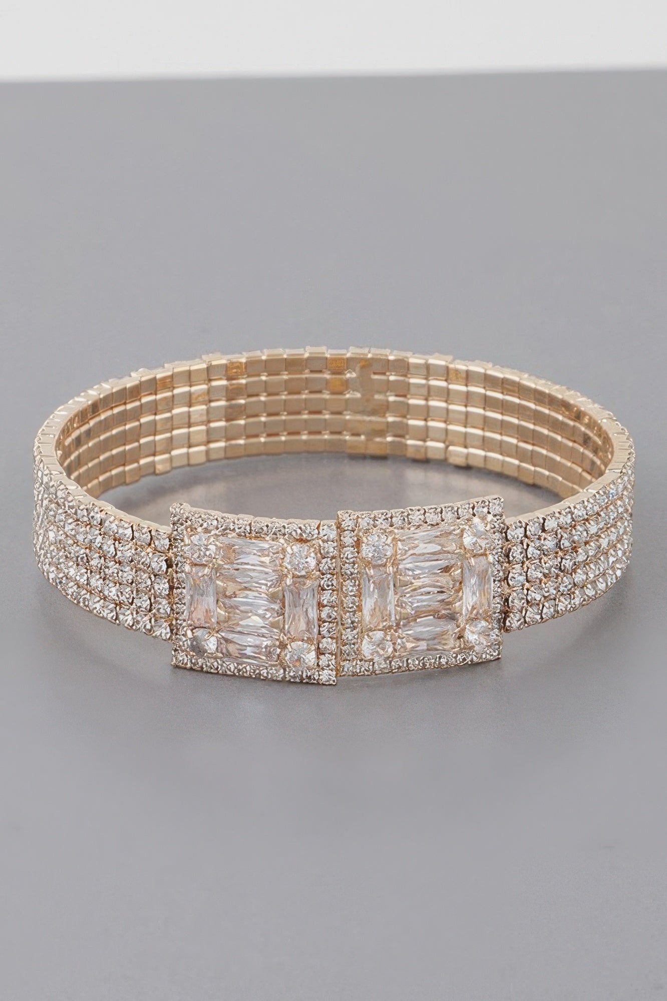 Crystal block bracelet in gold tone with wide clear stone center panel