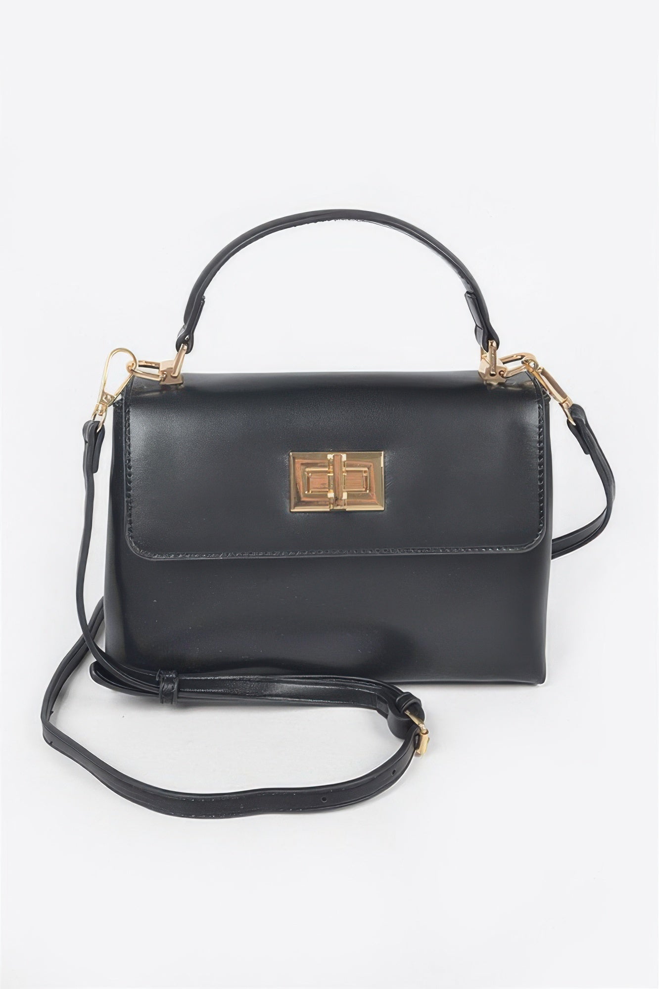 Black faux leather flap bag with gold clasp; top handle and crossbody strap