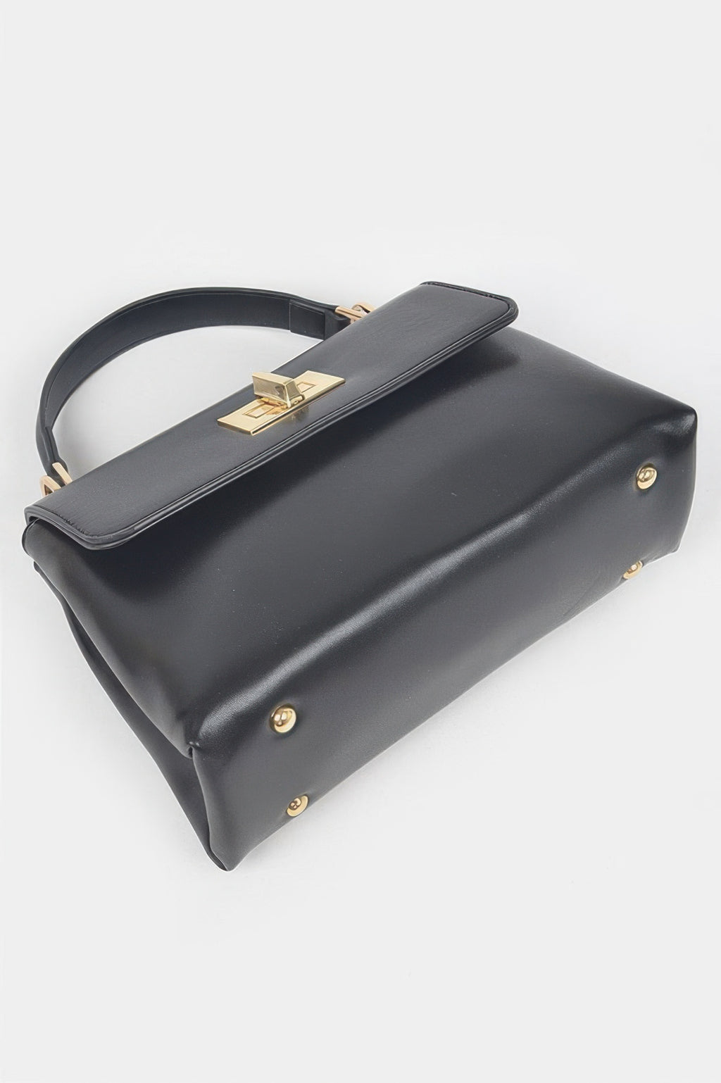 Black faux leather flap bag with gold clasp on top strap and back corner studs