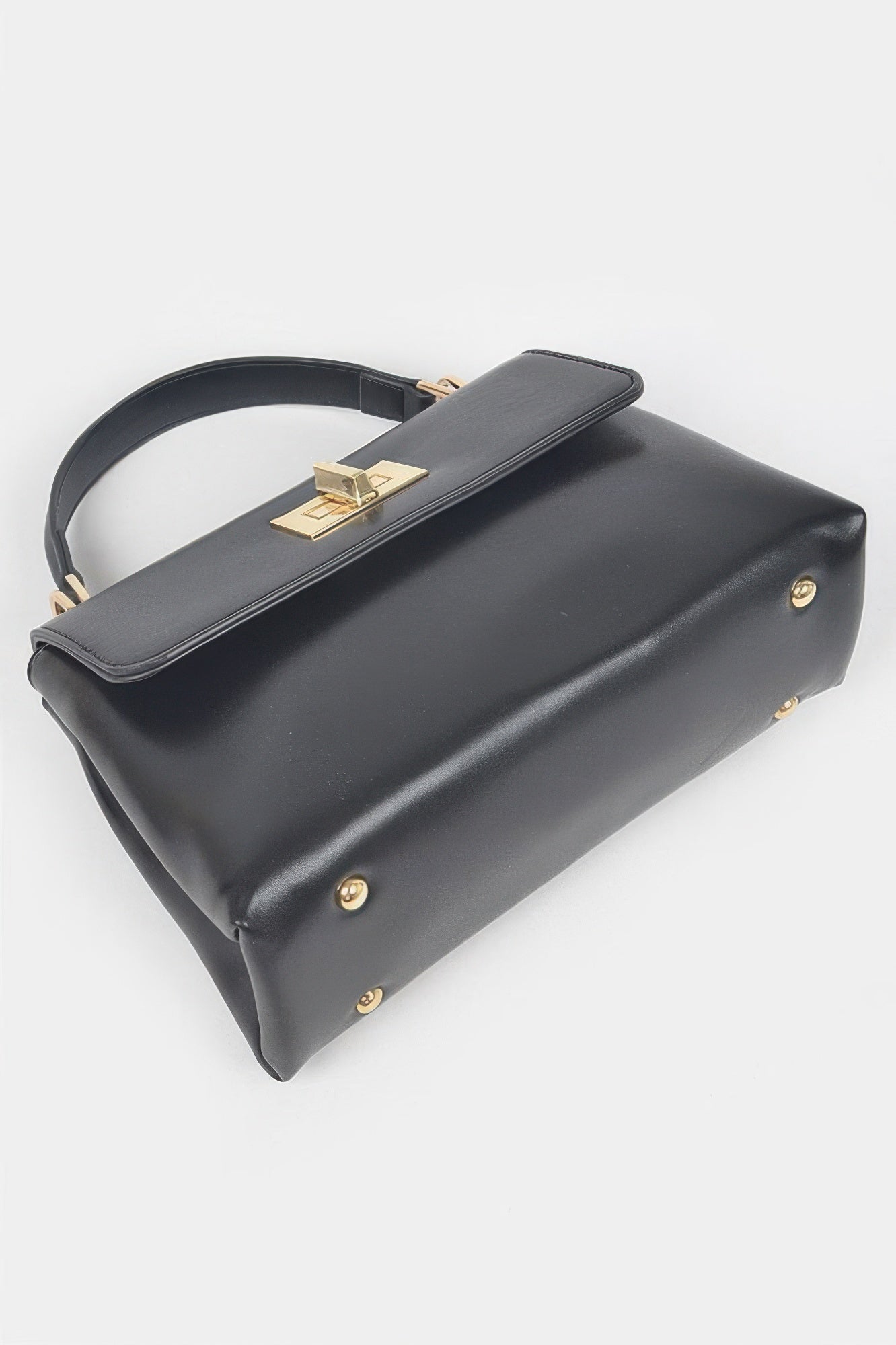 Black faux leather flap bag with gold clasp on top strap and back corner studs