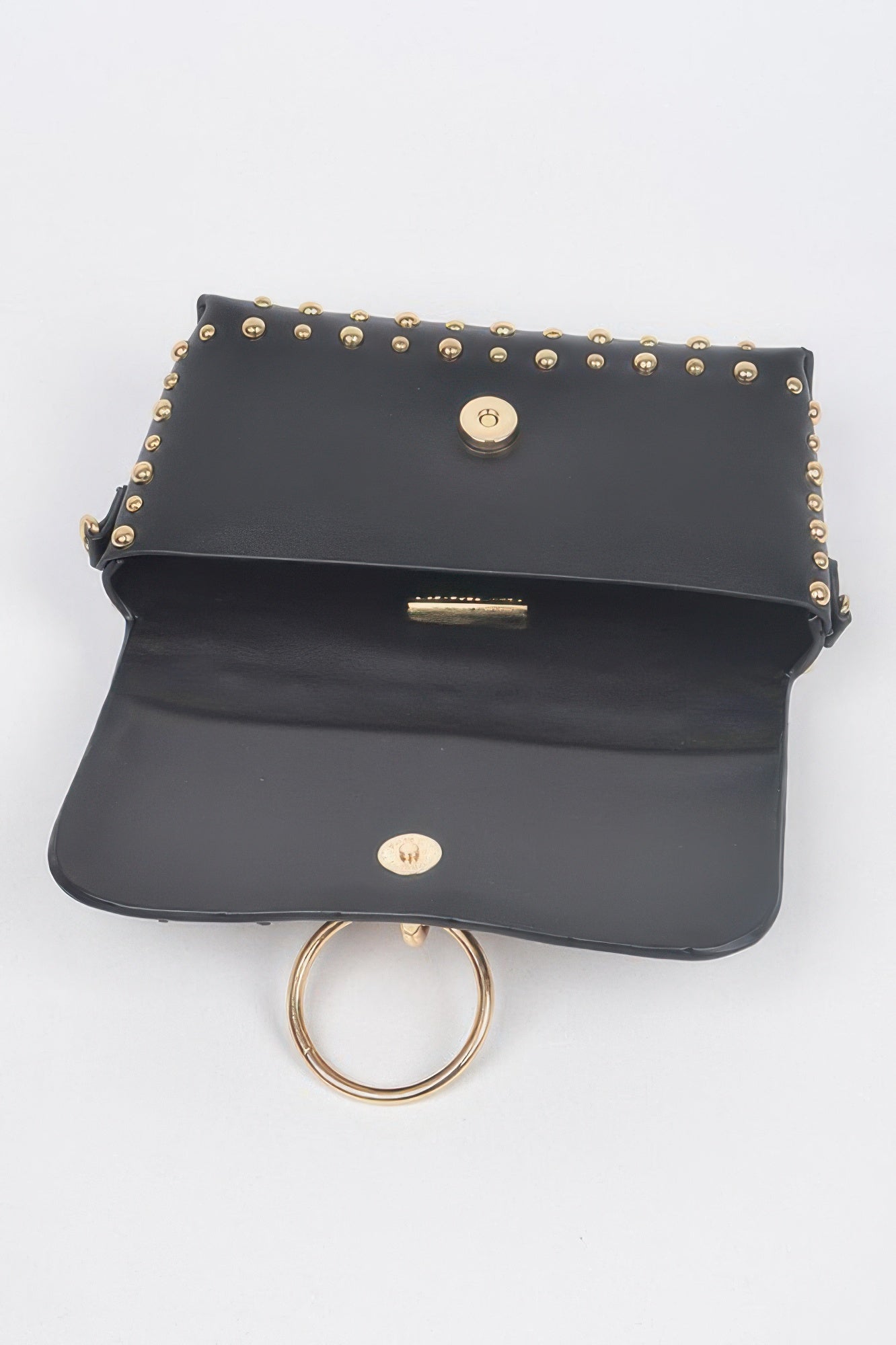 Black studded mini bag front flap with gold-tone snap and round ring detail