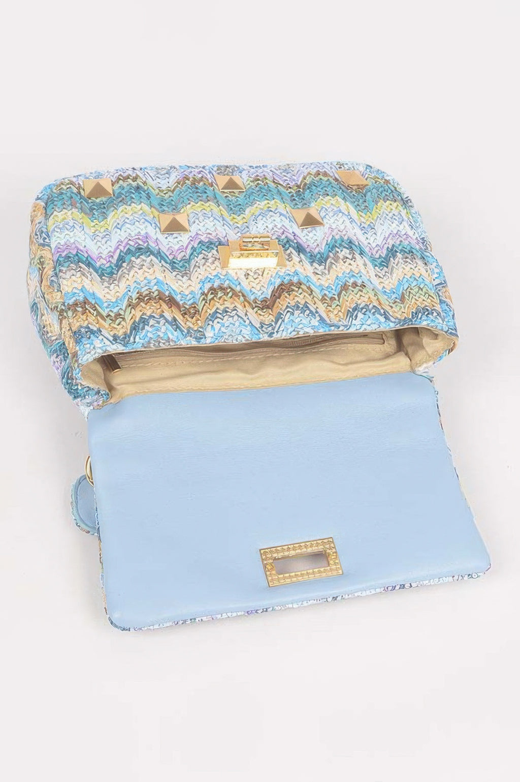 Blue faux straw flap bag open view with gold stud clasp and light-blue front panel