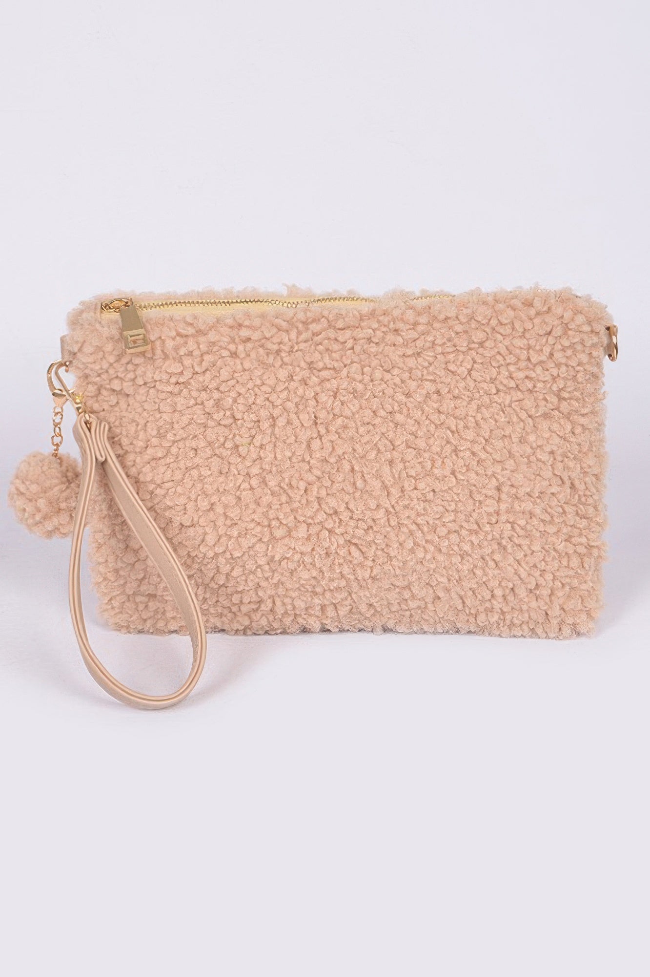 Beige faux fur clutch with top zipper, wrist strap, and small pom-pom charm