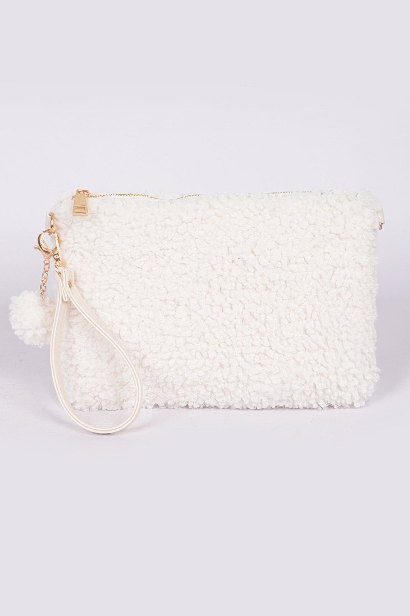 Ivory faux fur clutch with zipper top, wristlet strap, and round pom-pom charm