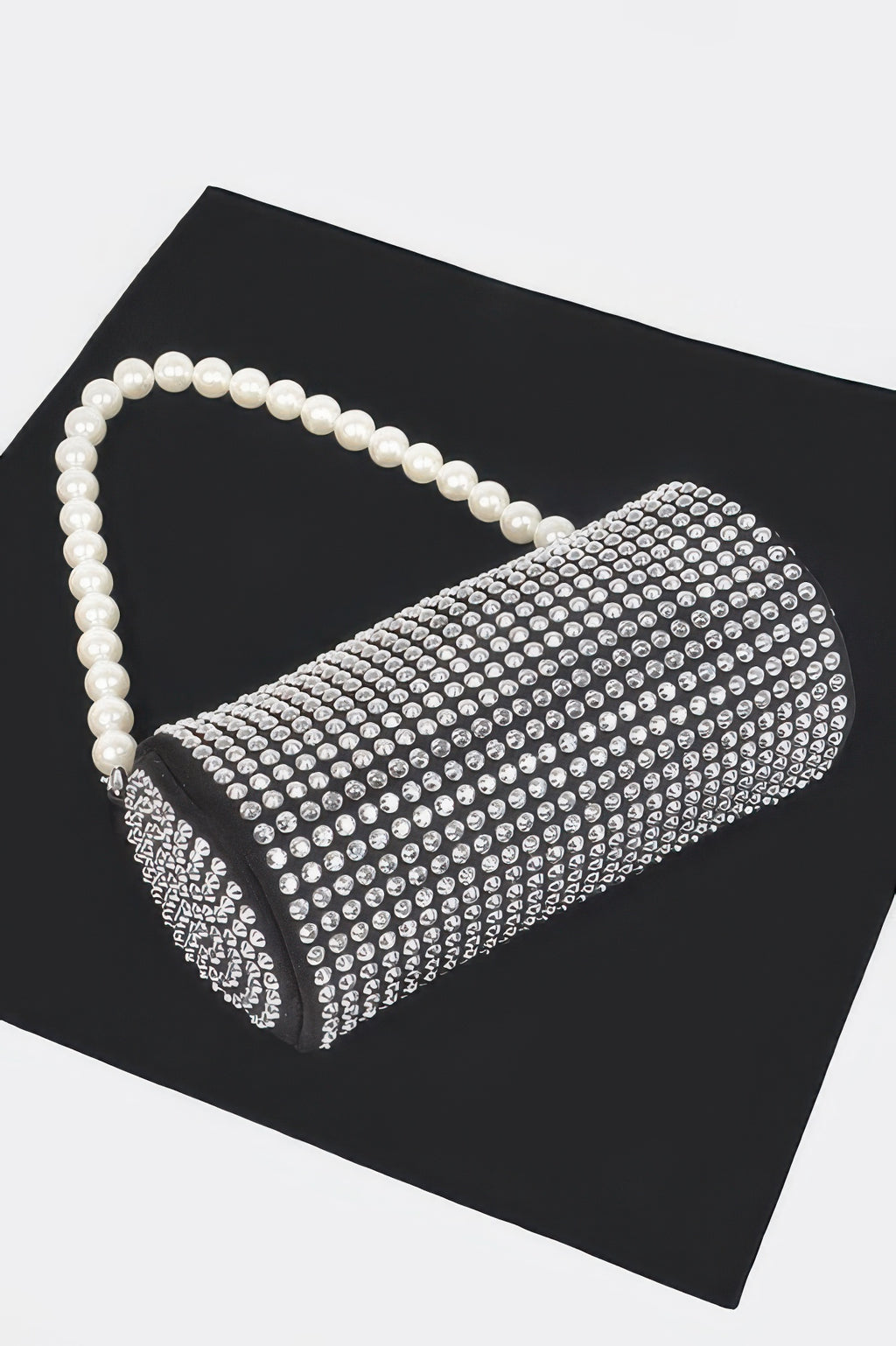 Black tube bag with all-over rhinestone mesh and pearl shoulder handle.