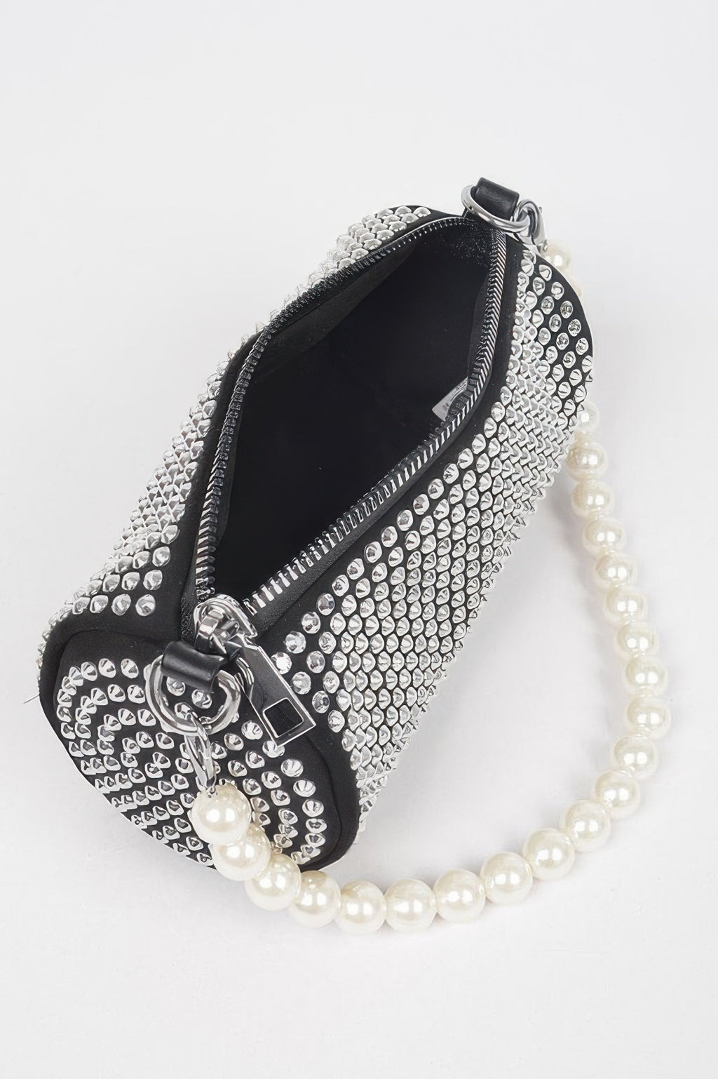 Black rhinestone tube bag with zipper top, pearl strap, and silver hardware.
