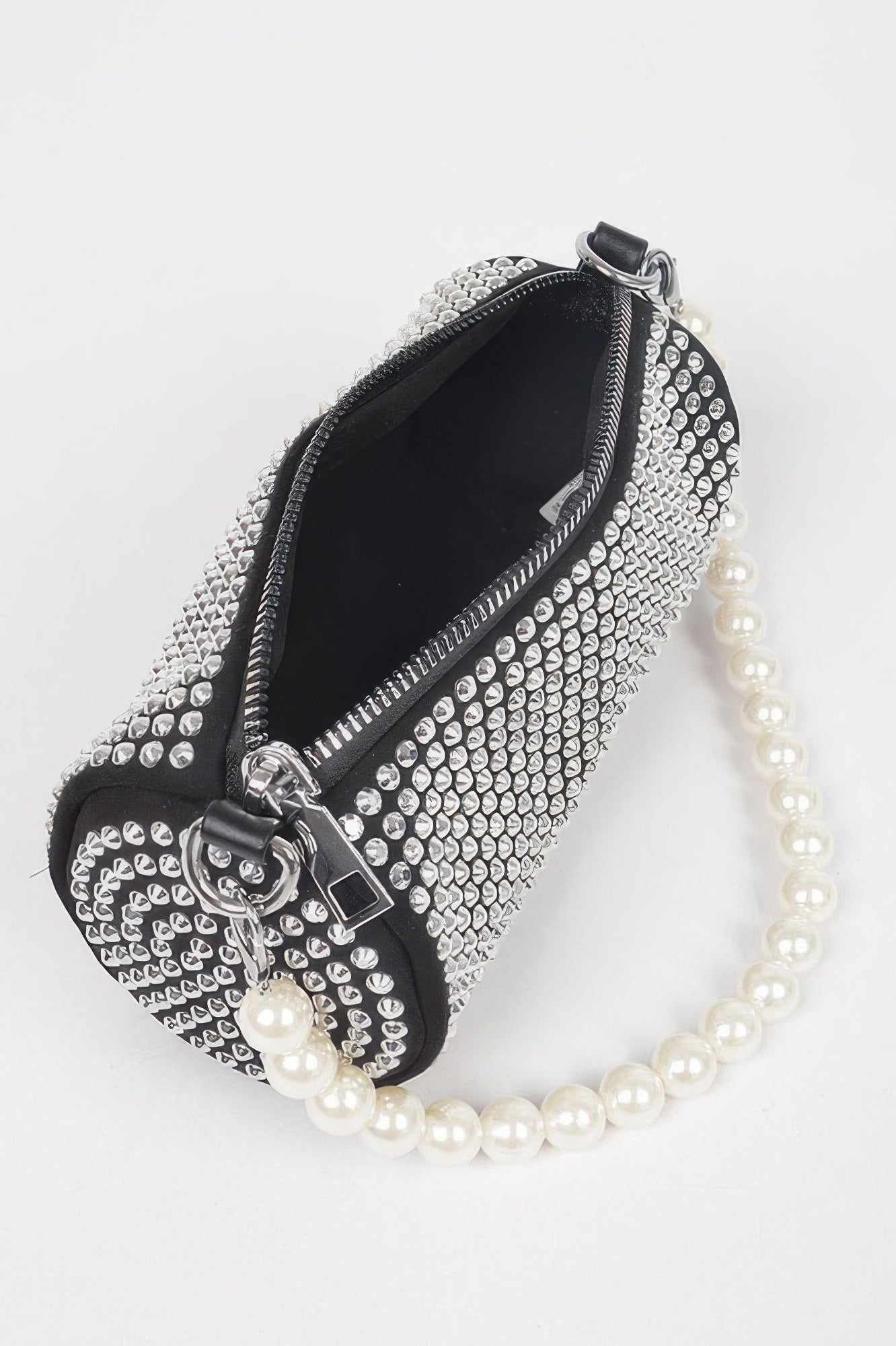 Black rhinestone tube bag with zipper top, pearl strap, and silver hardware.