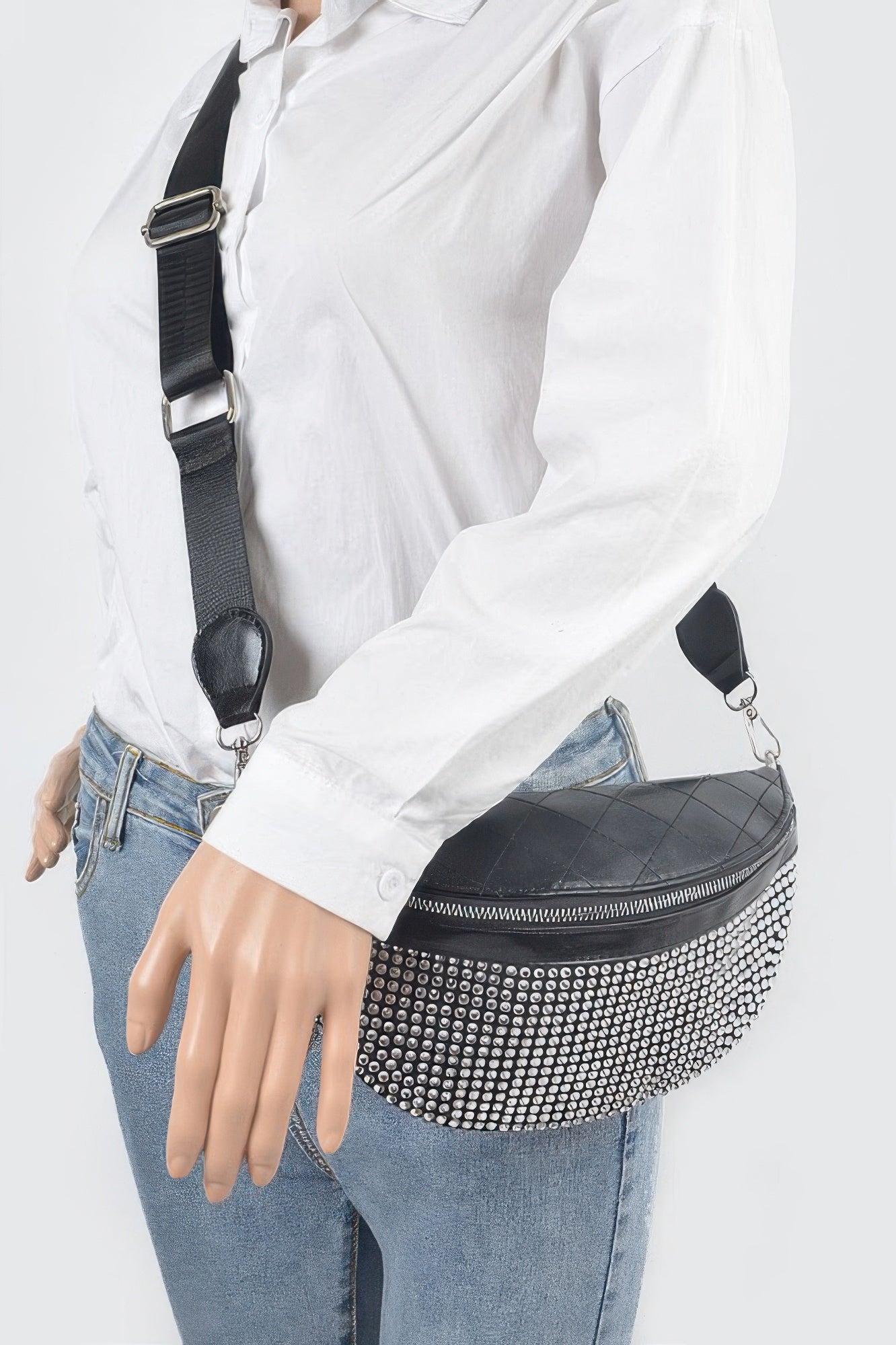Stone-studded fanny pack worn crossbody over light shirt and jeans, front zipper
