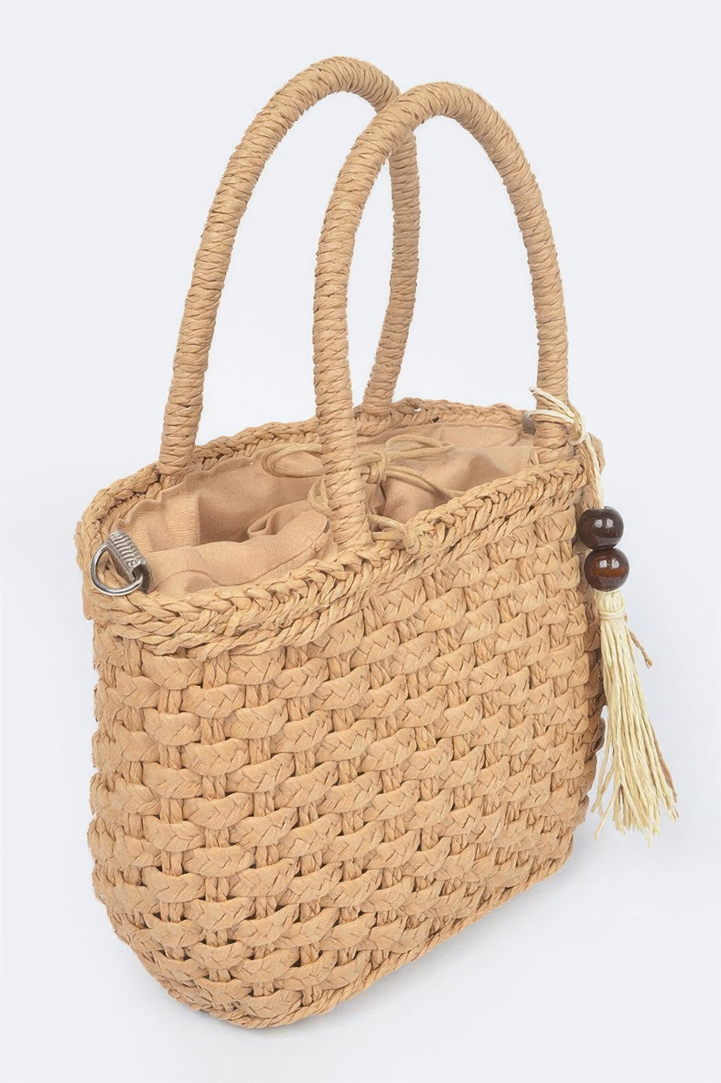 Khaki woven faux straw tote bag with long shoulder strap, ring hardware, tassel on side