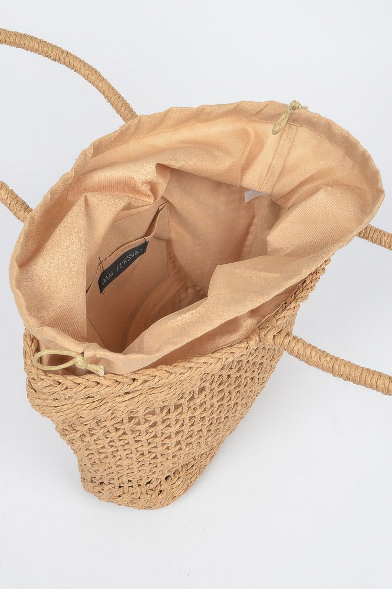 Khaki tote bag interior view with fabric lining, drawstring and woven sides.