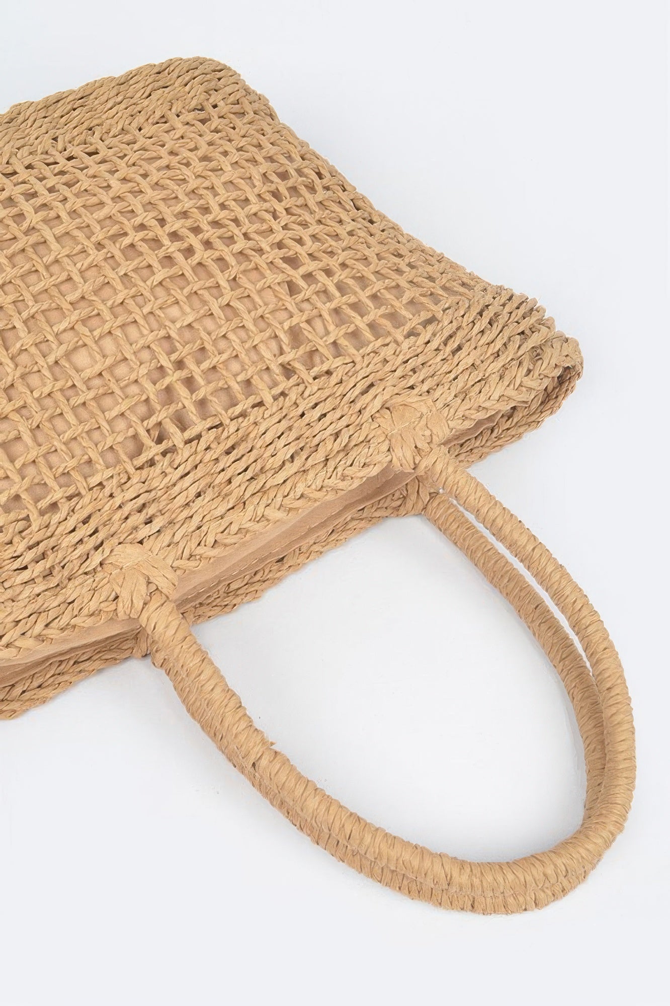 Close-up of Khaki woven tote bag with rope handles and textured lattice pattern.