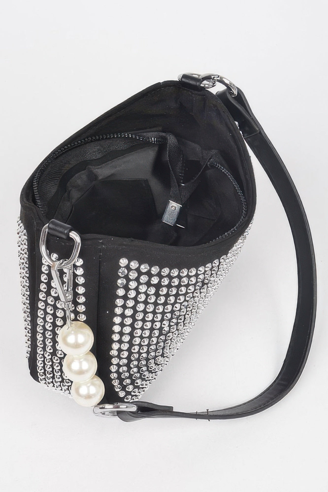 Black micro suede crossbody bag interior with open top, ring hardware, and pearl charm