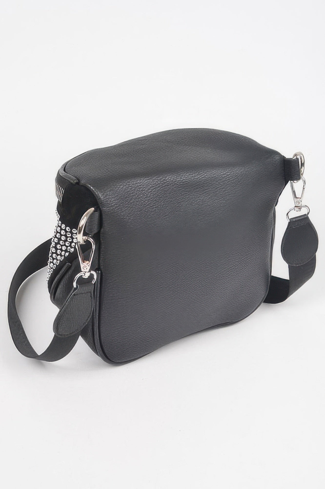 Side view of stone-studded crossbody bag, textured black body with silver dots