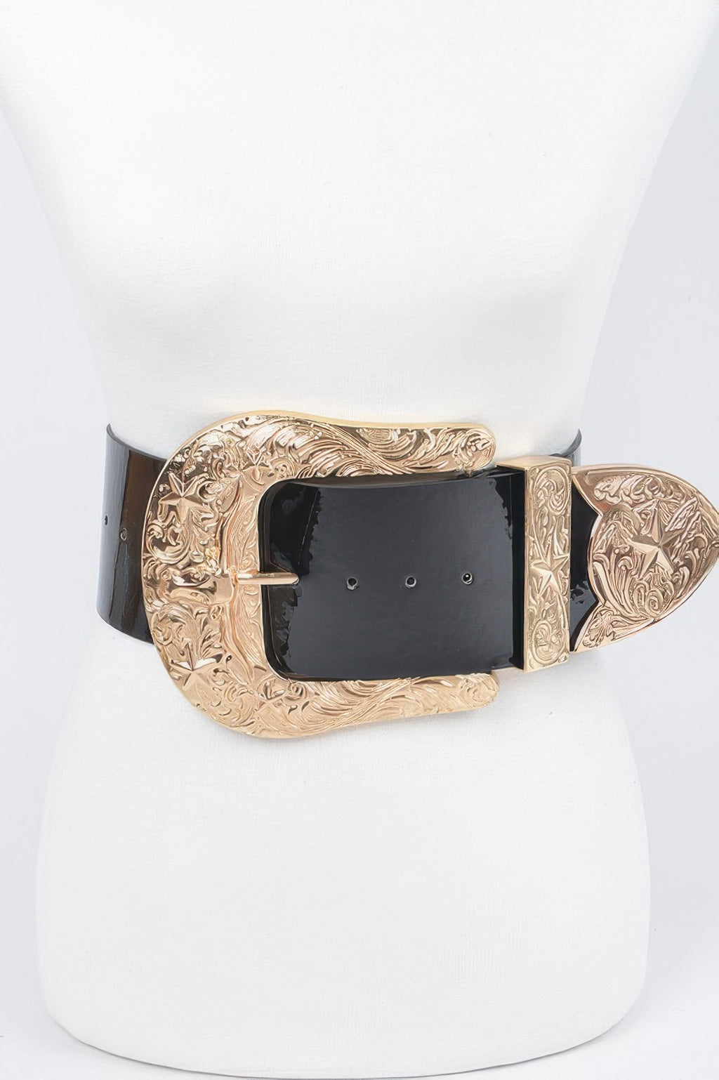 Oversized waist belt: black enamel strap with gold engraved buckle and decorative end pieces.