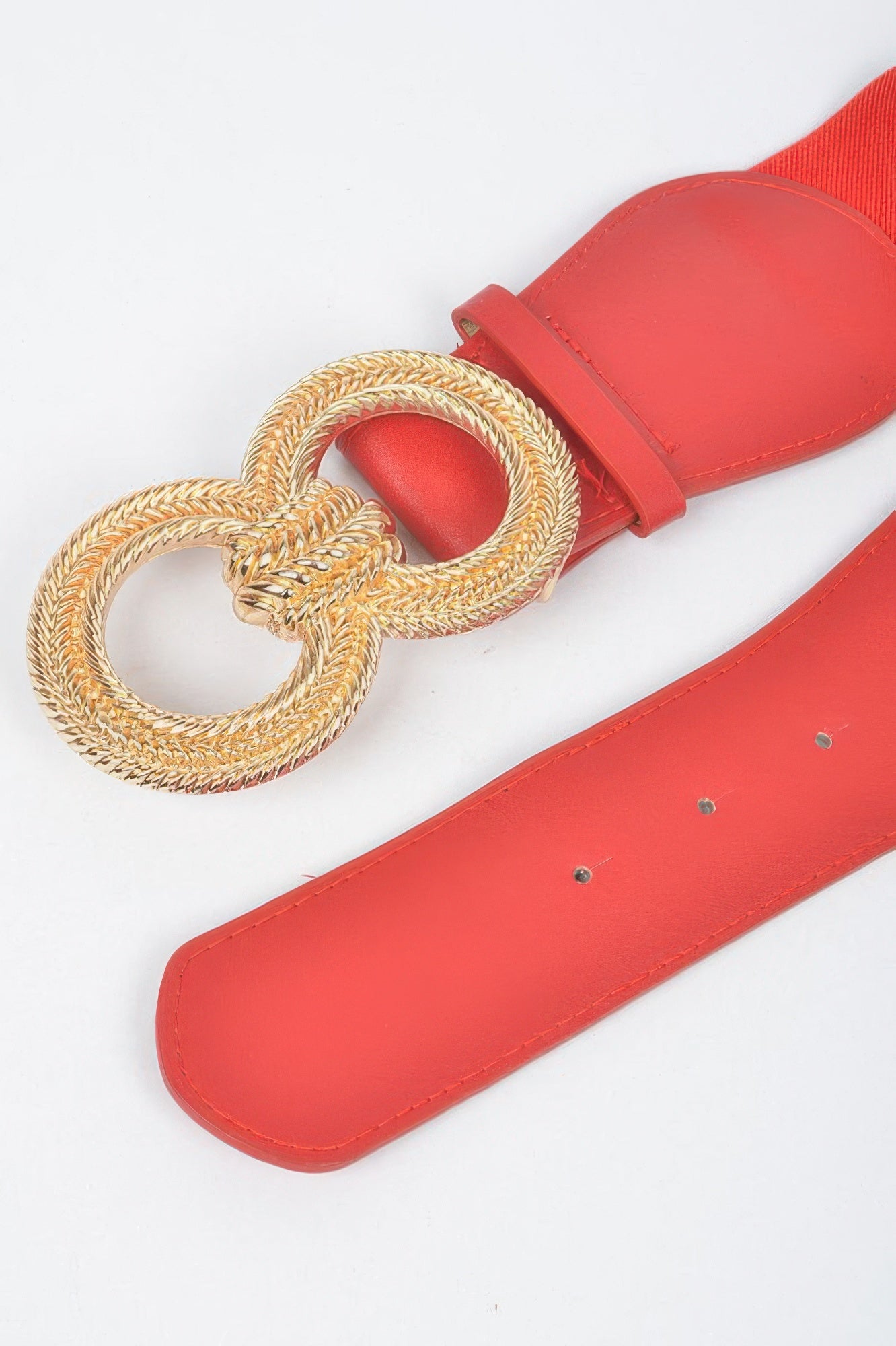 Close-up of red Knot Buckle Belt with gold braided knot and buckle loop
