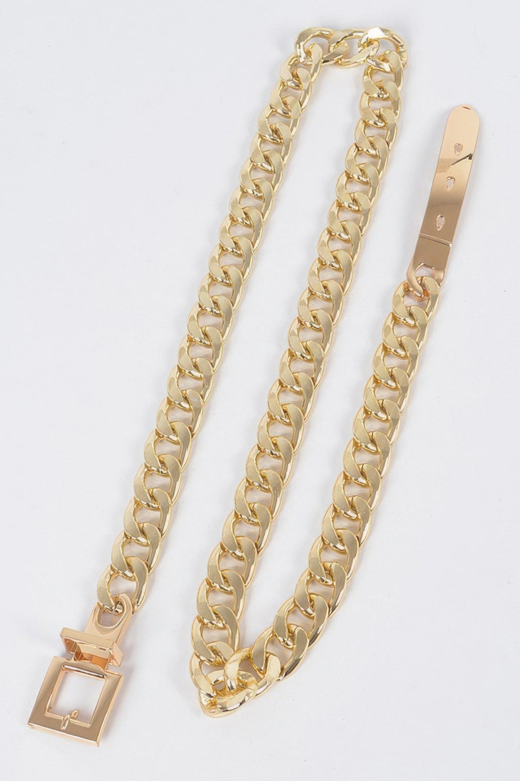 Gold chain belt with rectangular buckle and clasp, laid flat