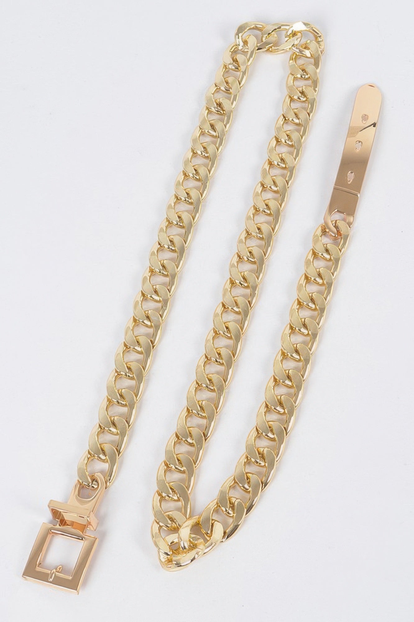 Gold chain belt with rectangular buckle and clasp, laid flat