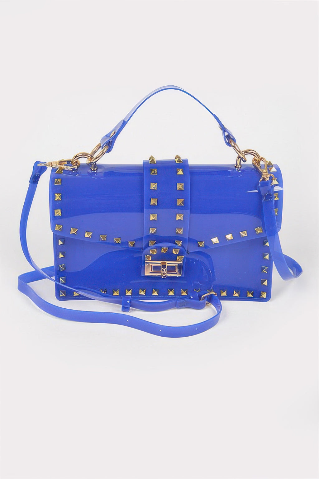 Cobalt transparent clutch with gold stud accents, top handle, and flap lock closure