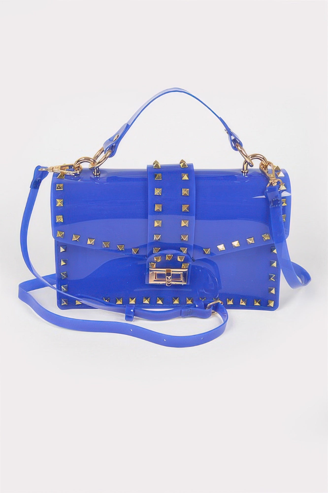 Cobalt transparent clutch with gold stud accents, top handle, and flap lock closure