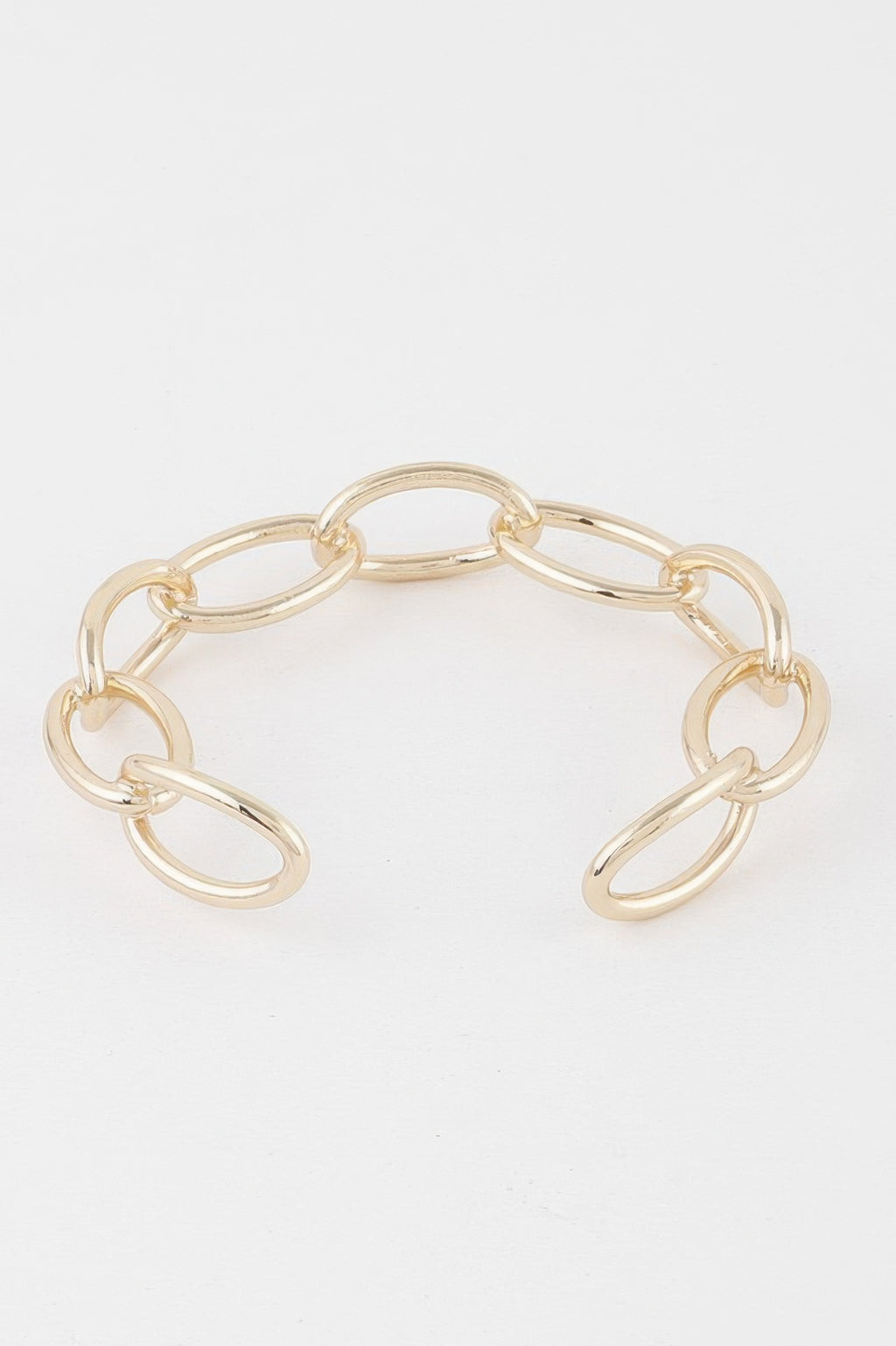 Gold link chain cuff bracelet showing oval links in an open cuff design