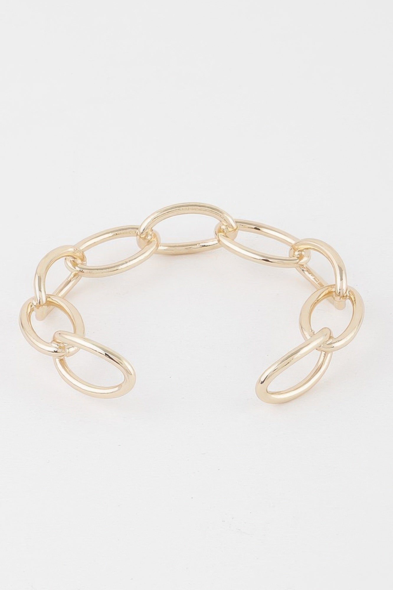 Gold link chain cuff bracelet showing oval links in an open cuff design