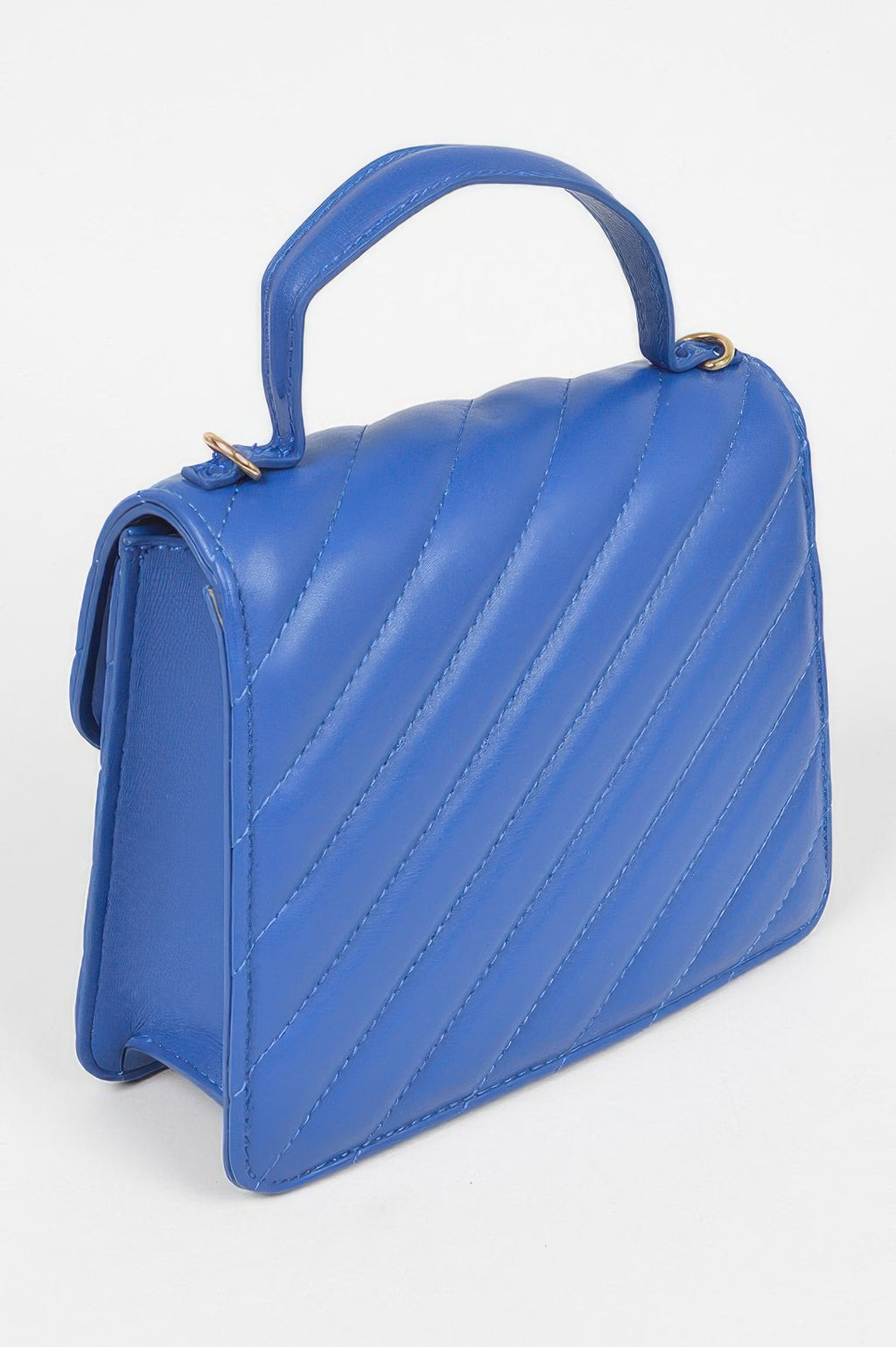 Cobalt blue quilted flap top handle bag, side view with stitched diagonal lines