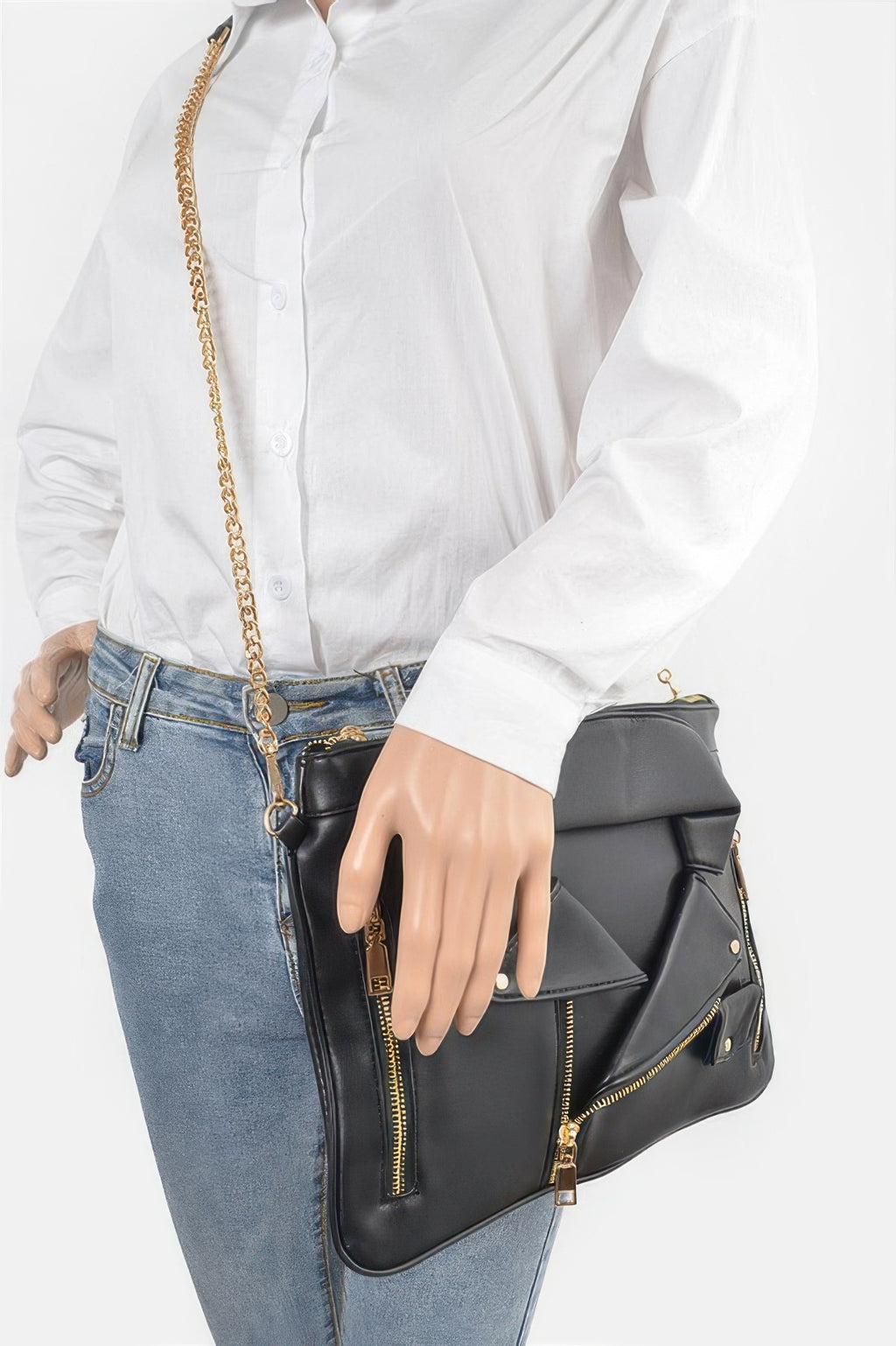 Faux leather novelty bag worn crossbody, black with gold zippers and chain strap