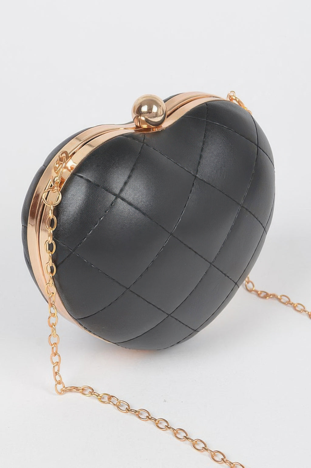 Black quilted heart crossbody bag with gold-tone clasp and long chain strap