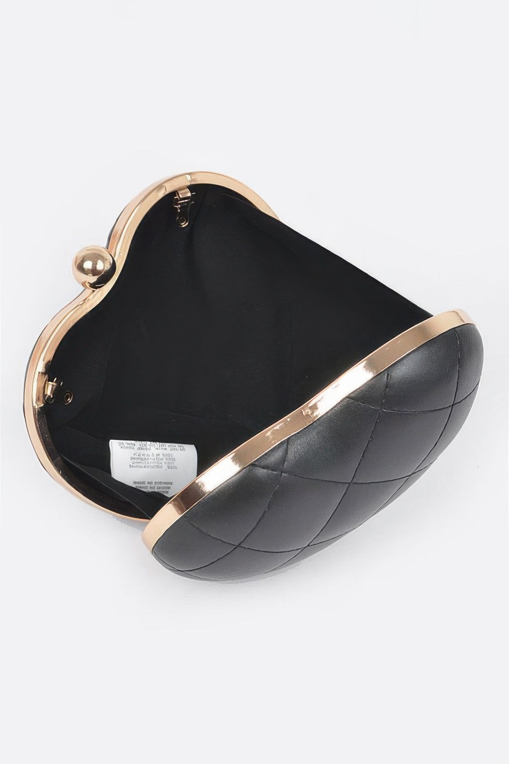 Black quilted heart crossbody bag interior, open top with gold frame and clasp