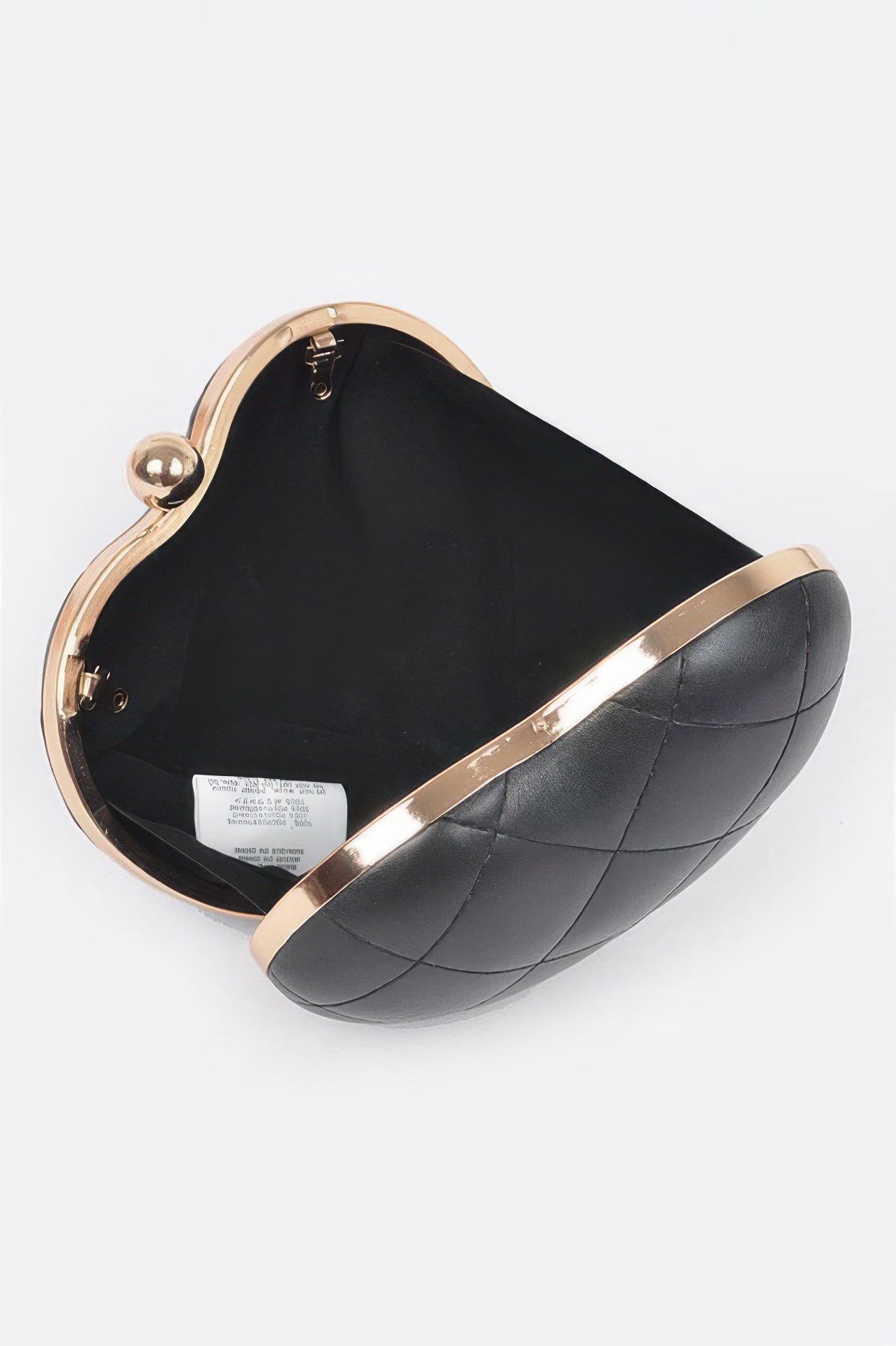 Black quilted heart crossbody bag interior, open top with gold frame and clasp