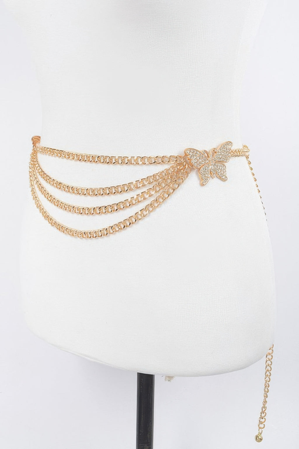 Layered gold chain belt with large butterfly buckle at the front