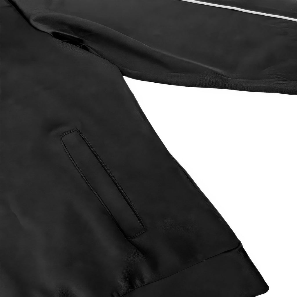 Black track jacket sleeve with vertical zip pocket detail and stitched panel