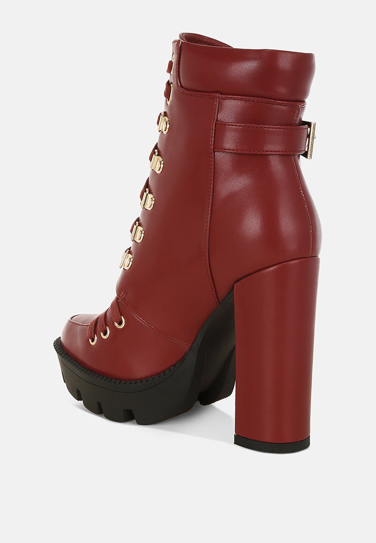 Burgundy combat boot with front lacing, buckle straps, and tall block heel