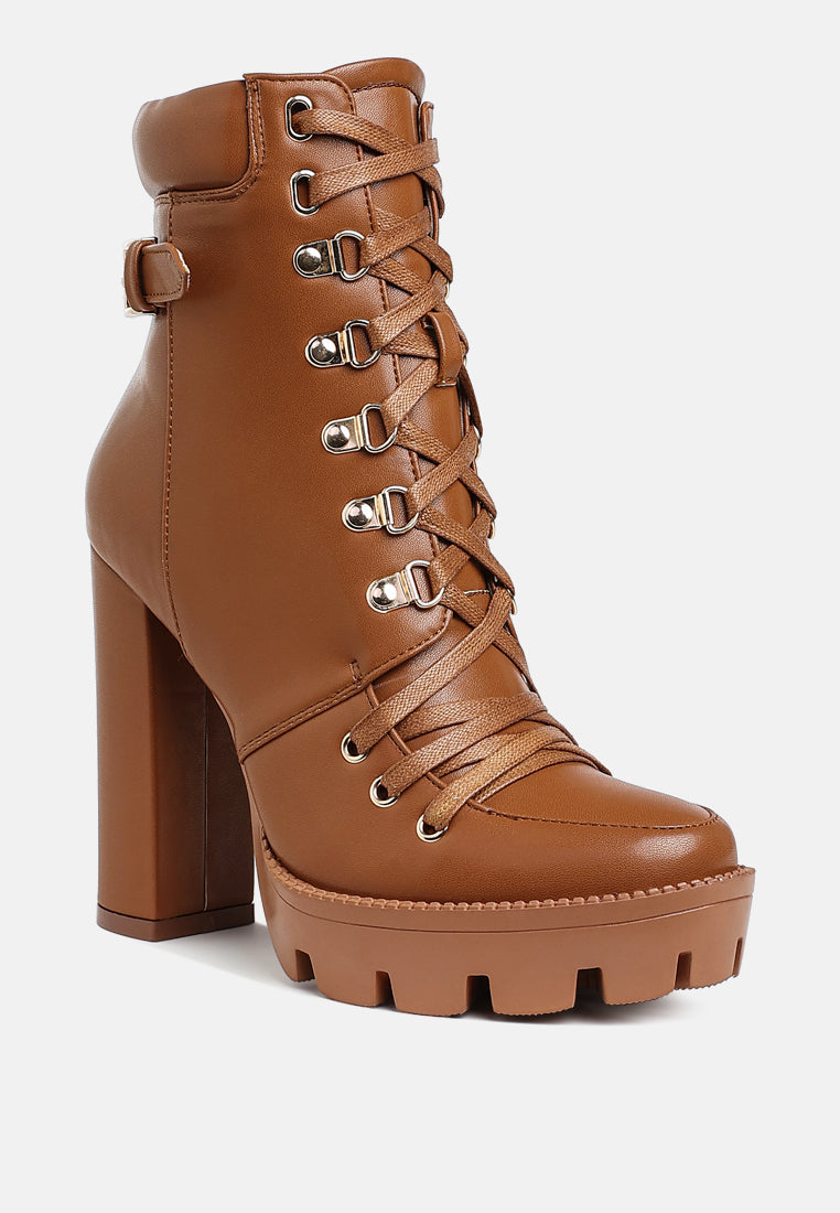 Tan combat boot with high block heel, lace-up front, and buckle strap