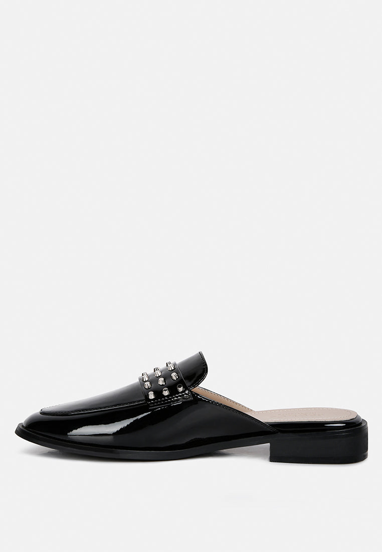 Black patent flat mule side profile with silver studs on upper