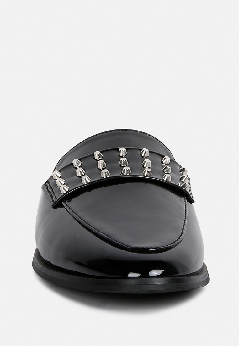 Black patent flat mule front view with dense silver stud cluster on toe