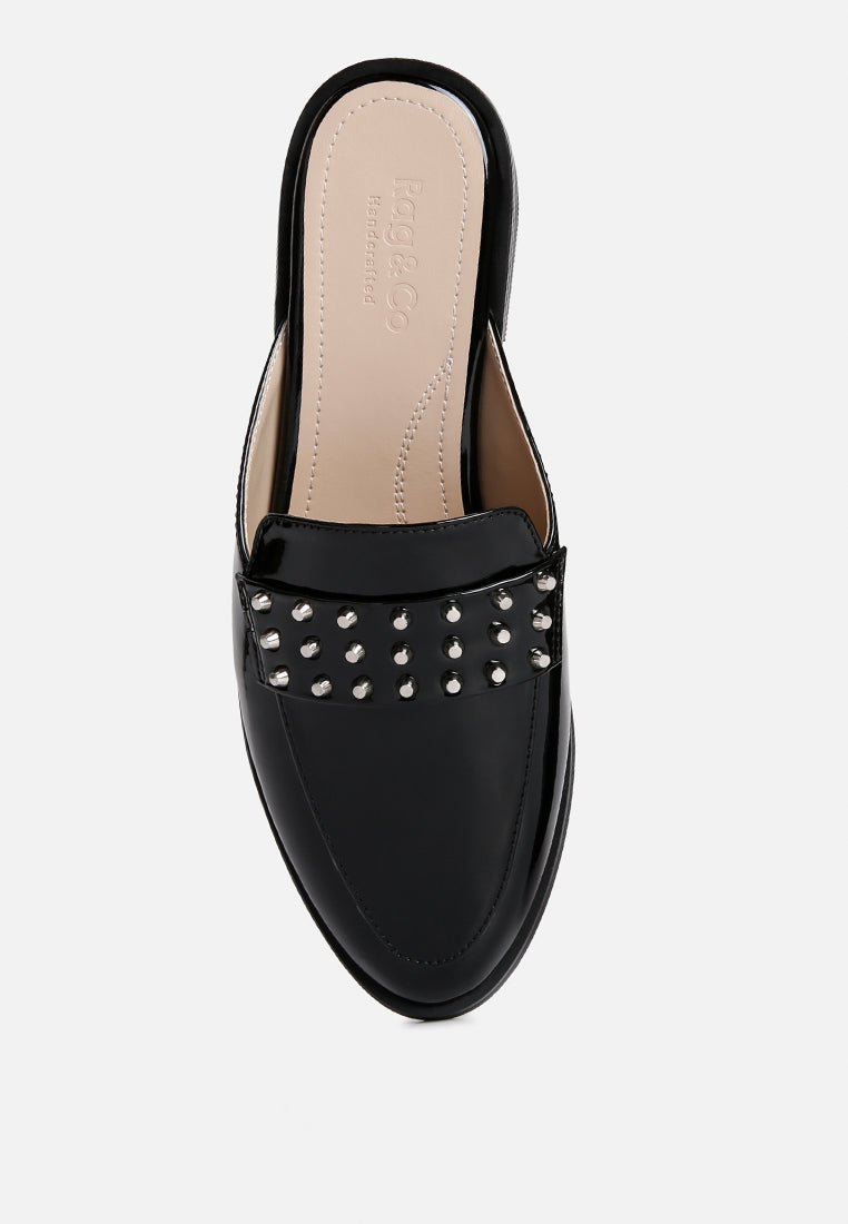 Black patent flat mule top view of studded band across the front