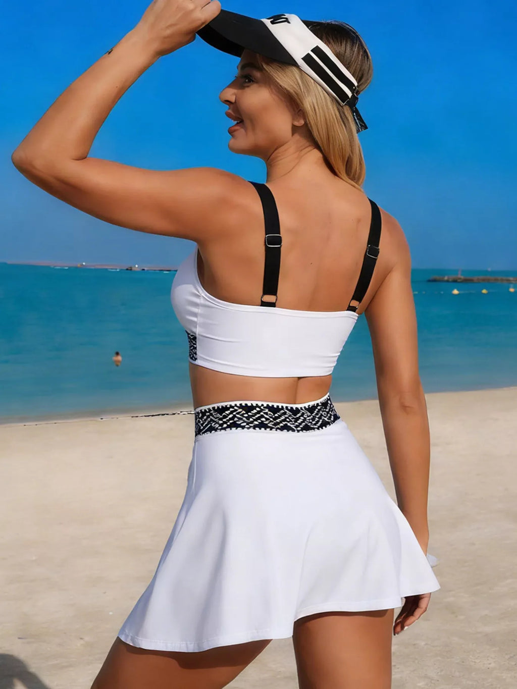 White tank and skort swim set, rear view with black straps and patterned waist band