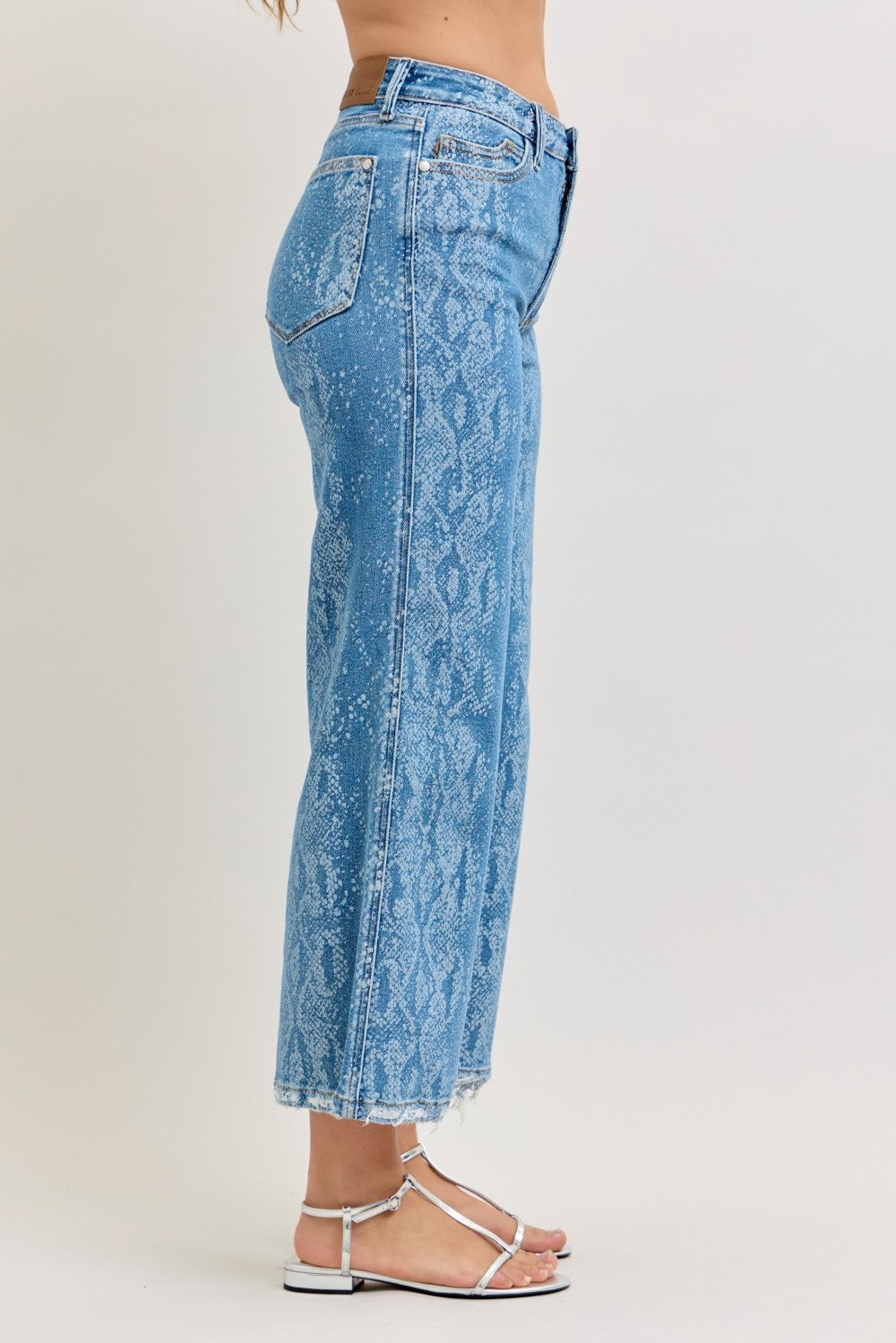 High-rise ankle wide-leg jeans in blue snake-print, side seam detail, frayed hem.
