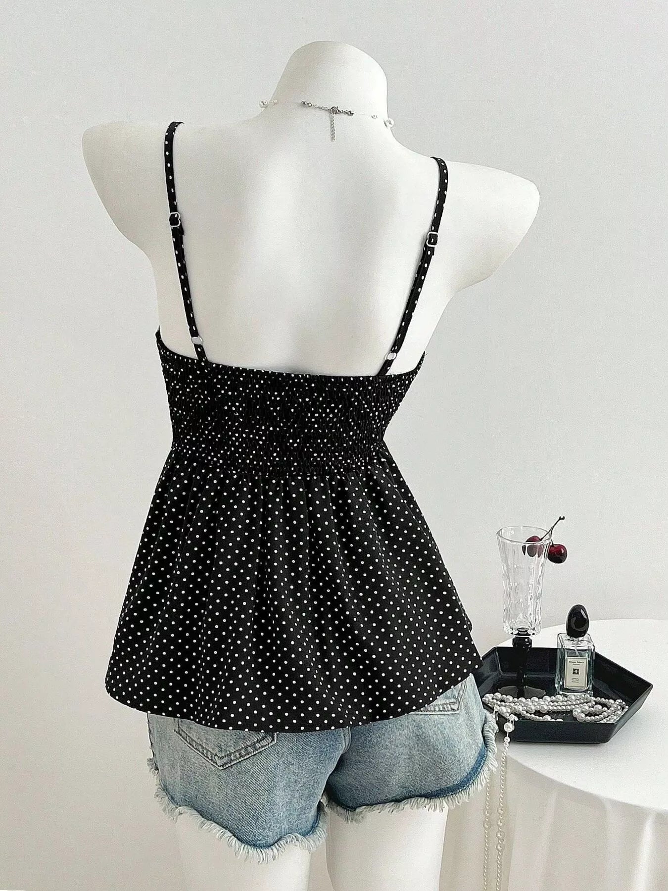 Black polka dot cami back view with adjustable straps and scooped neckline