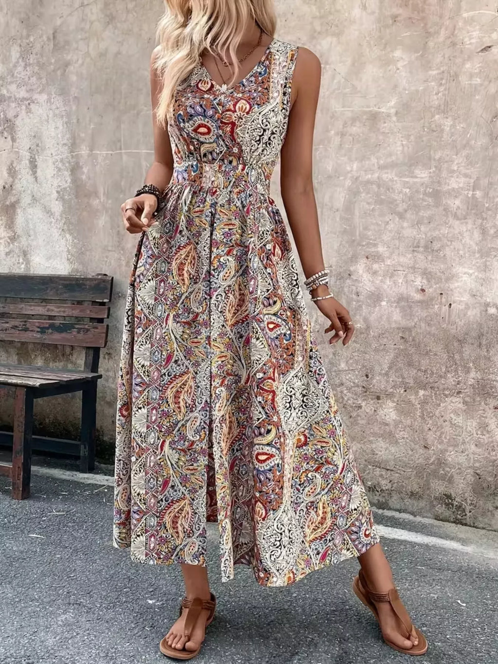 Tan multicolor paisley sleeveless romper with long top, cinched waist and flowing hem
