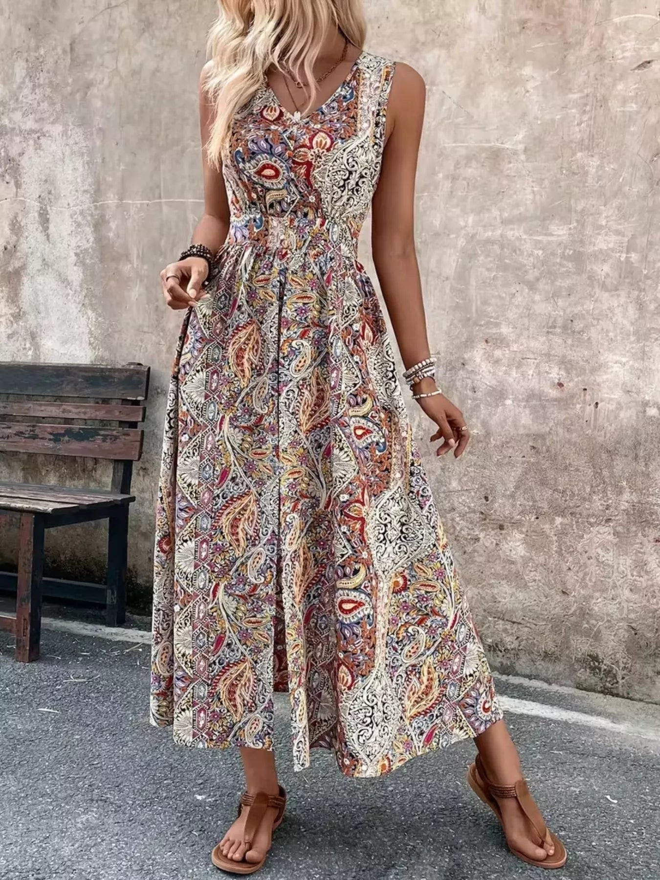 Tan multicolor paisley sleeveless romper with long top, cinched waist and flowing hem
