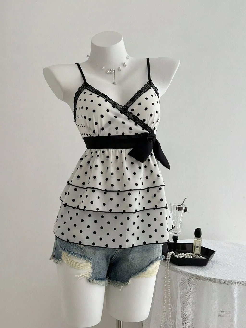 Black polka dot cami with lace trim and ruffle hem, tiered peplum style