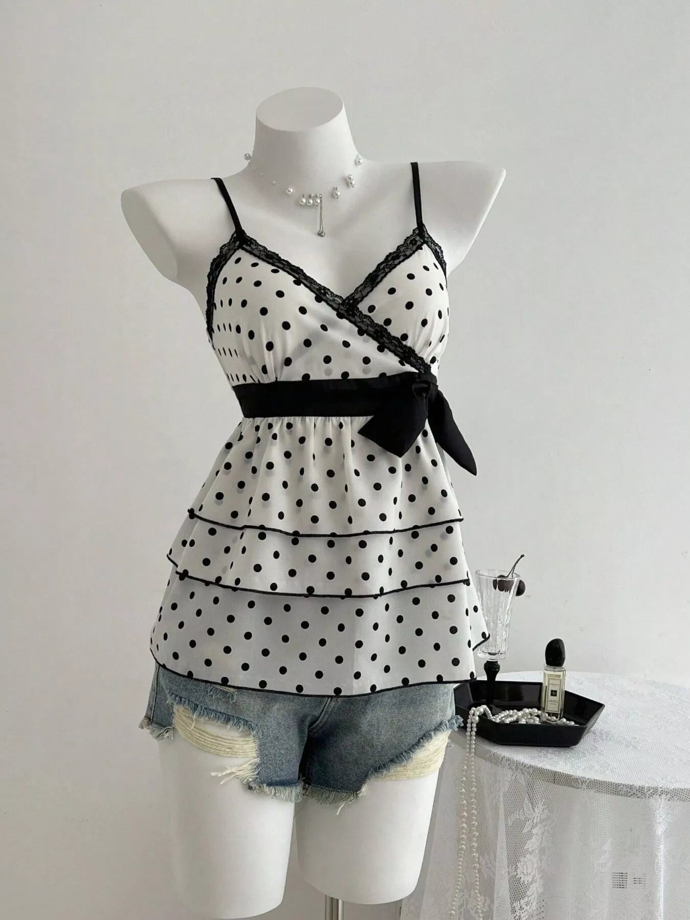 Black polka dot cami with lace trim and ruffle hem, tiered peplum style