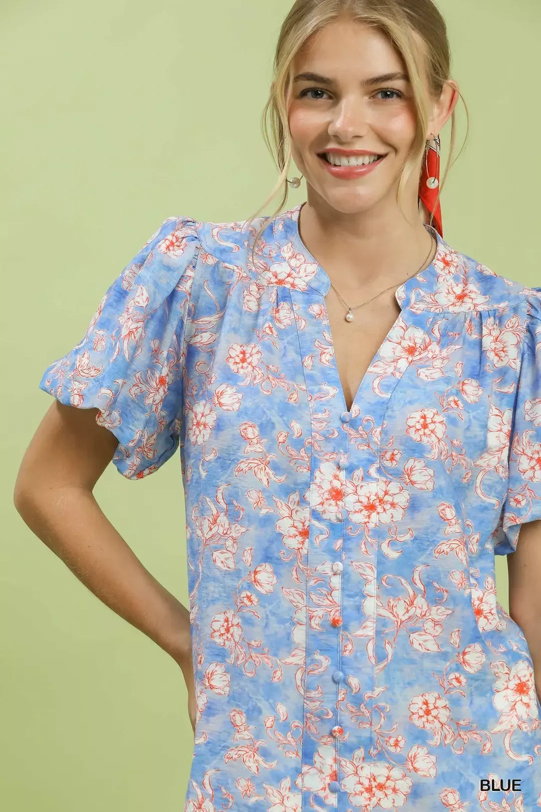 Close-up of blue floral button-front V-neck short-sleeve shirt