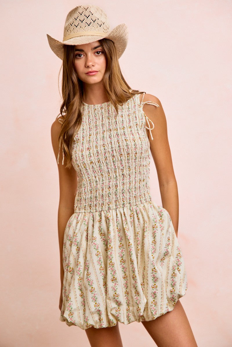 Ivory floral mini dress with smocked bodice, gathered puff sleeves, and ruched skirt