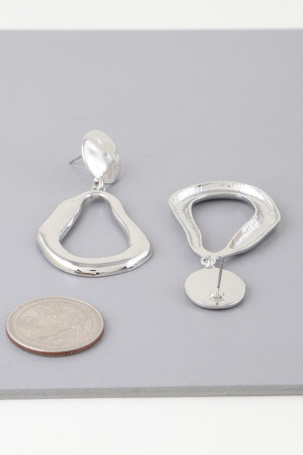 Abstract shiny teardrop earrings, silver-tone with teardrop dangle and backing disc
